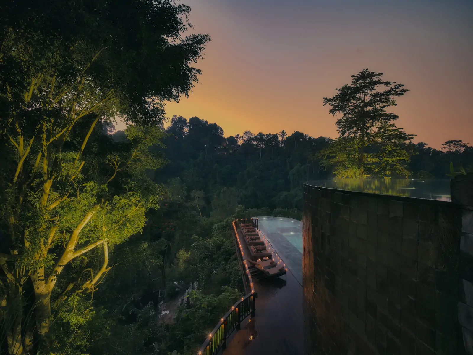 Hanging Gardens of Bali rainforest valley at sunset with warm light and tranquil setting